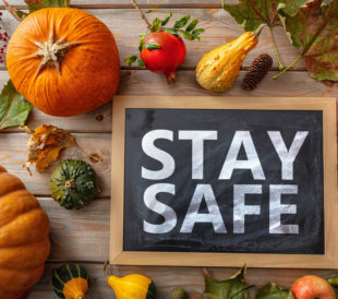 Stay Safe sign on a Thanksgiving background