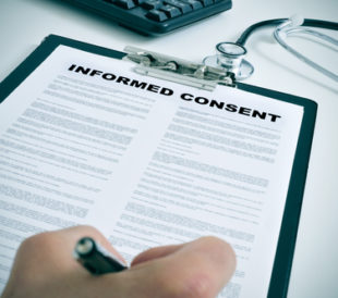 Person signing an informed consent form.