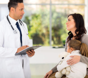 Doctor consulting a mother and child in hospital. Image: michaeljung/Shutterstock.com