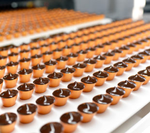 chocolate coated snacks being manufactured