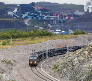 electric iron ore train passing mine operations